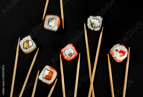Set of Japanese sushi isolated on black backgound. Top view