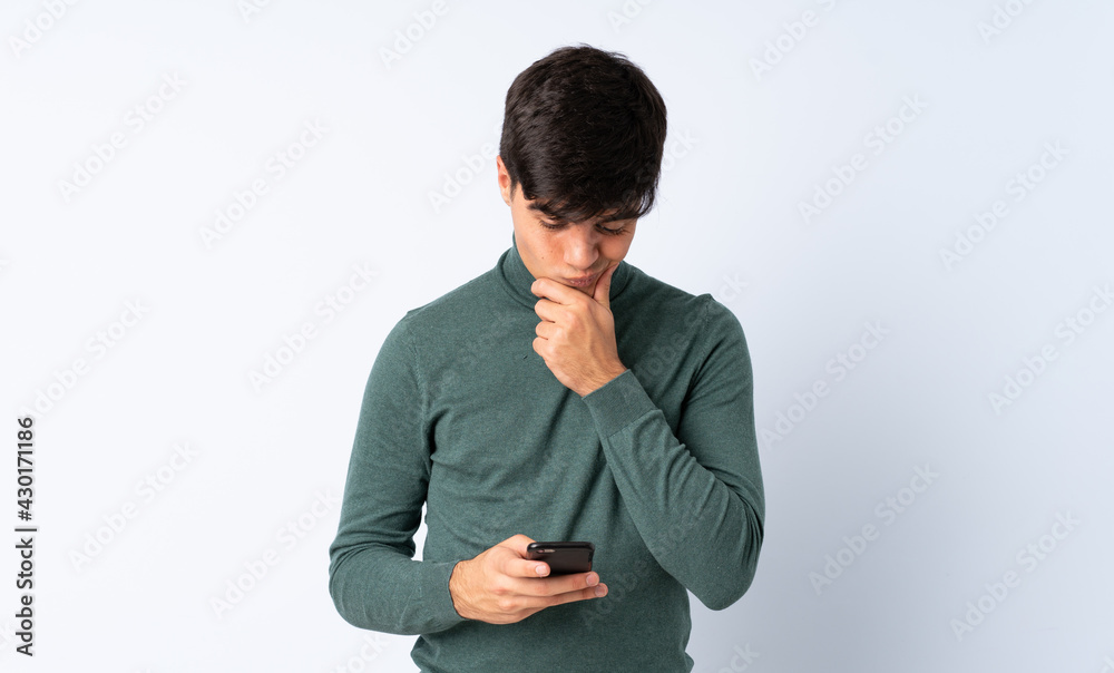 Handsome man over isolated blue background thinking and sending a message Handsome man over isolated blue background thinking and sending a message