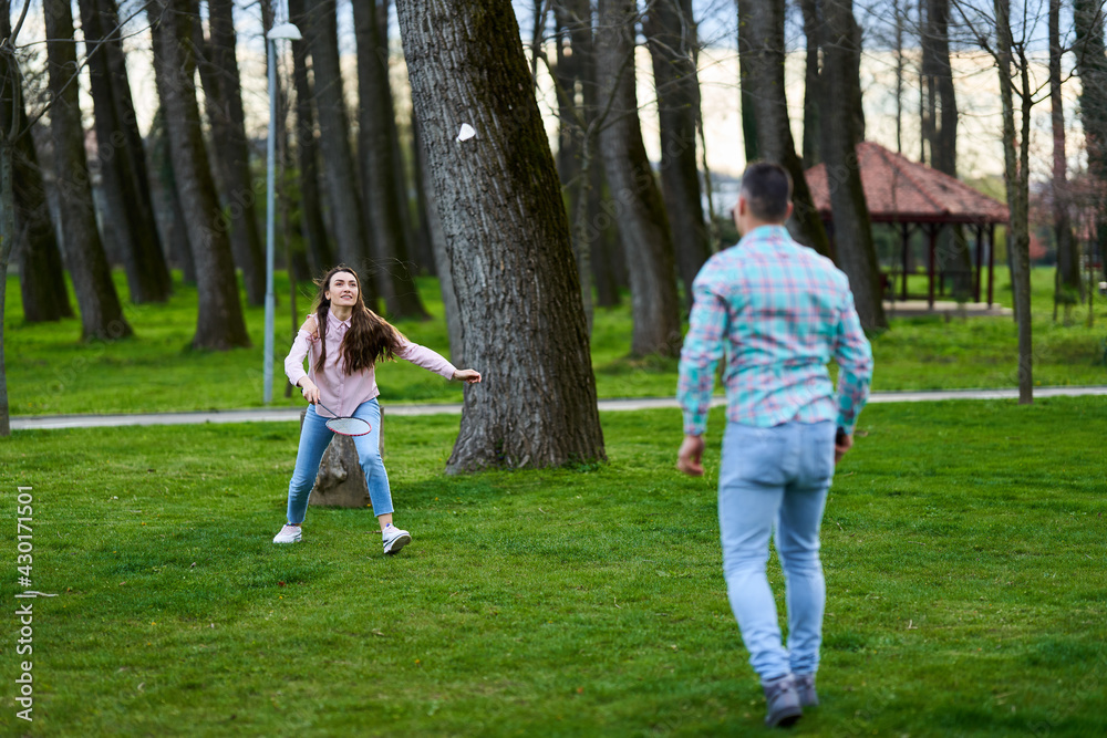 Couple playing badminton in the park