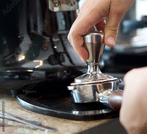 Barista making fresh espresso coffee. Espresso Machine Portafilters (Closeup).