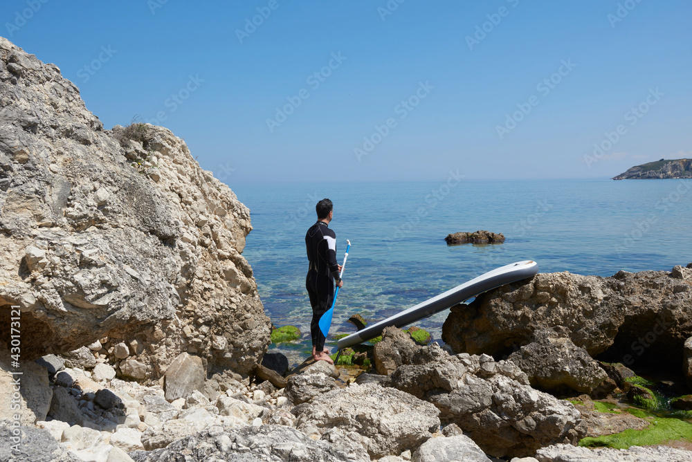 Obraz premium Man is playing paddle board, swimmer with swimming suit.
