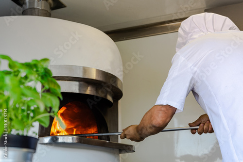 Pizza Chef Baking Pizza in Wood Fired Oven in Mobile Pizza Food Truck