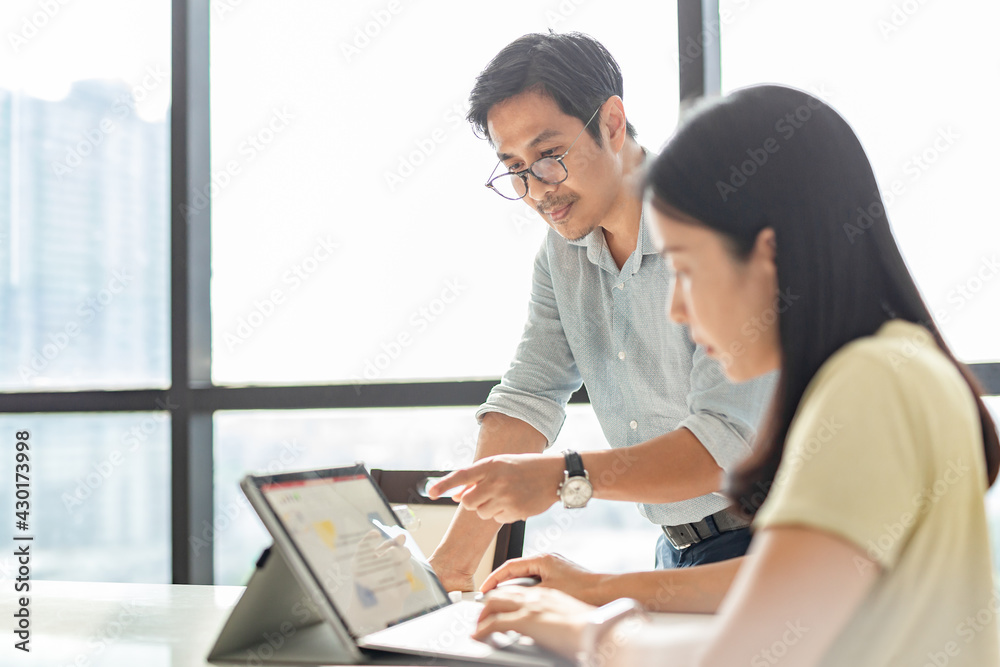 Businessman hand pointing at computer working with female on a project. Businessman hand pointing at computer working with female on a project.