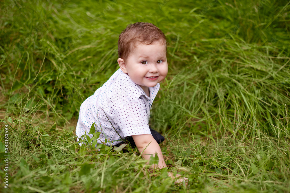little boy playing in green grass. world children's day content little boy playing in green grass. world children's day content