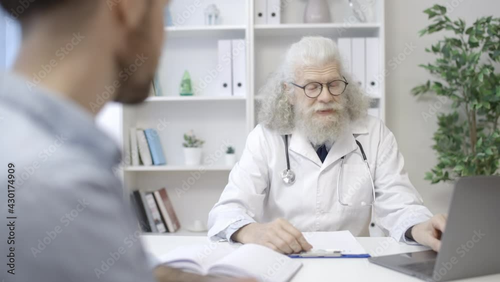 Professional urologist talking to male patient in clinic, men's health, checkup Professional urologist talking to male patient in clinic, men's health, checkup