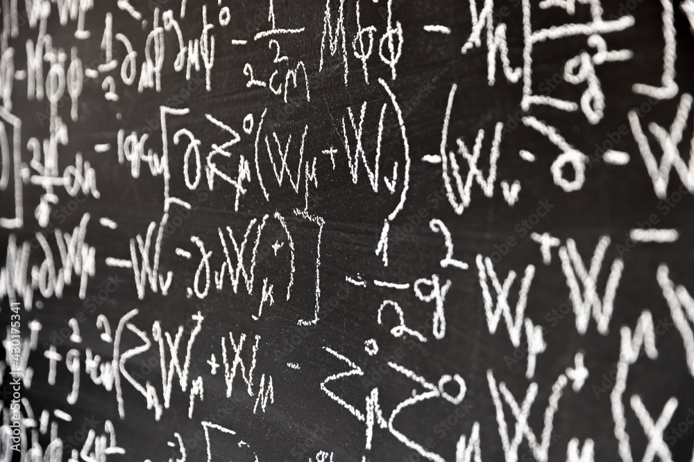 Mathematical formulas on dark black chalk board