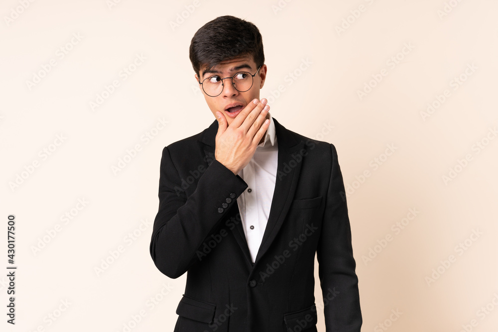 Businessman over isolated beige background thinking an idea Businessman over isolated beige background thinking an idea