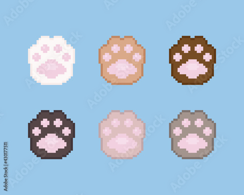 Pixel paws illustration icon set. Vector pixel art paws icons. 8 bit or 16 bit retro game style animal paws icon collection. Pixel cute cartoon cat or dog paws isolated icons on blue background.
