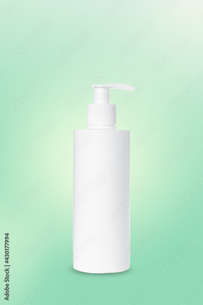 empty white plastic pump bottle for cosmetics on green background. Mockup empty white plastic pump bottle for cosmetics on green background. Mockup