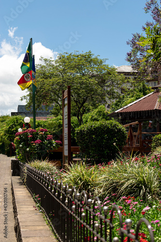 Bandeiras do Brasil, Rio Grande do Sul e Gramado hasteada próximo à calçada em via pública na cidade de Gramado. photo
