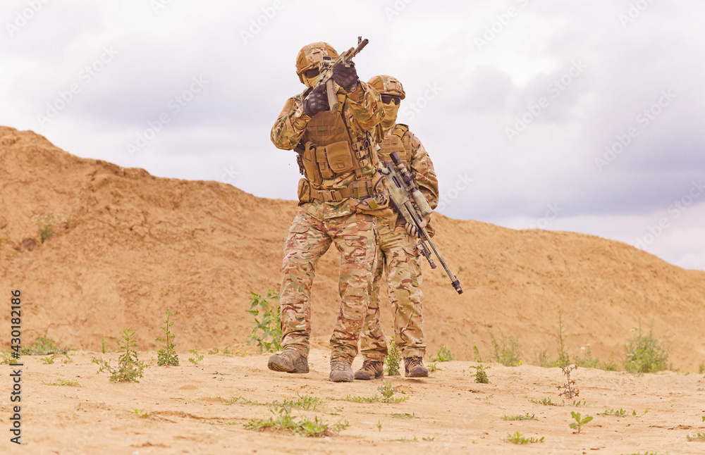 Equipped and armed special forces soldiershooting on the battlefield. Concept of military anti-terrorism operations, special operations of NATO forces.