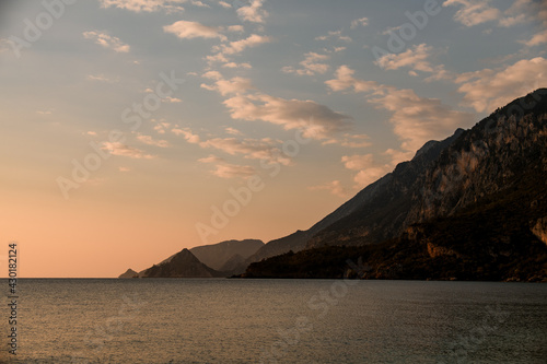 beautiful landscape view of sea mountains and sky in the evening at sunset © fesenko