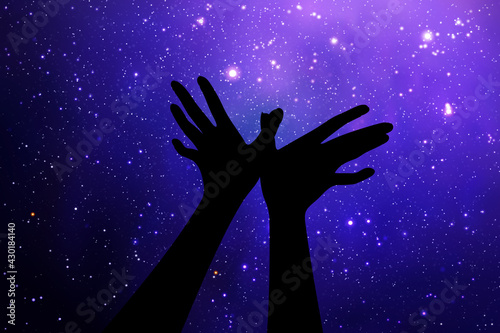 Heart shaped hands. Hand gesture silhouette. Starry sky and Milky Way