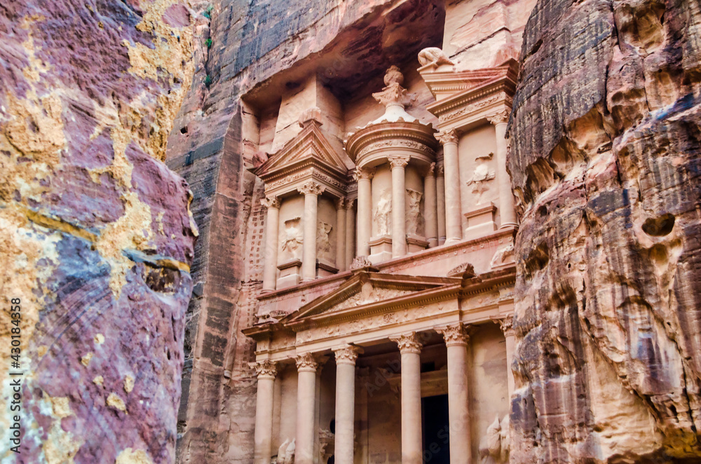The Treasury in the heritage site of Petra. With coloured rocks in the foreground