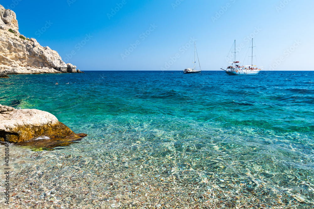 crystal clear water of Traganou Beach on Rhodes island in Greece