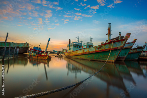 Many boats moored in sunrise morning time at Chalong port, Main port for travel ship to krabi and phi phi island, Phuket, Thailand photo