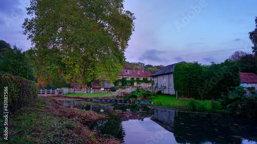 Stedham, UK - October 20, 2020:  Autumn colours and sunset on the River Rother and Stedham Mill in the South Downs National Park, West Sussex, UK © Julian Gazzard