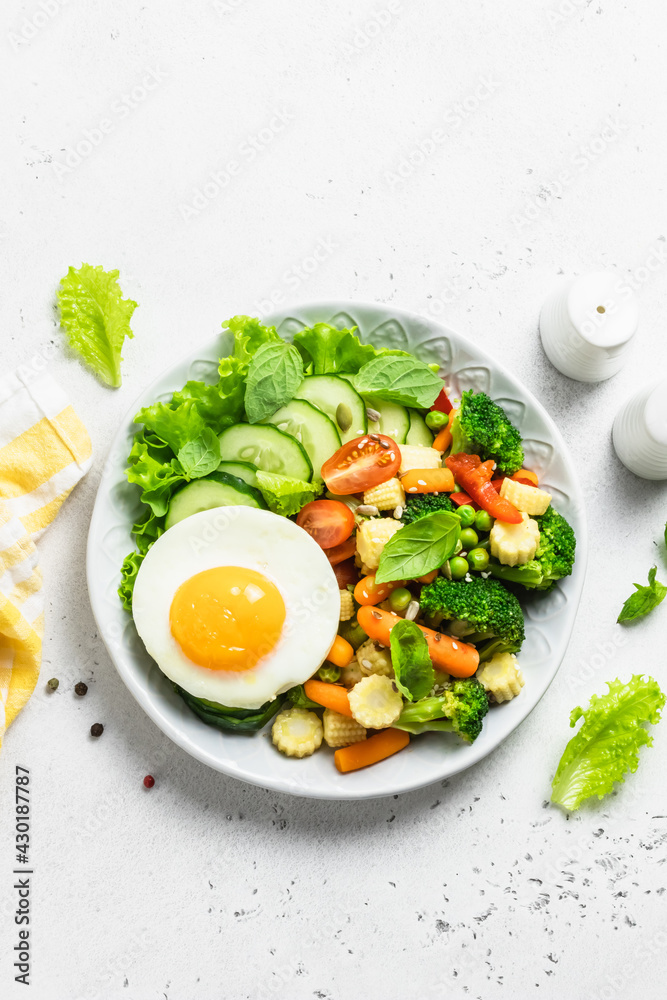 Salad vegetables fried egg bowl. Top view, space for text. Salad vegetables fried egg bowl. Top view, space for text.