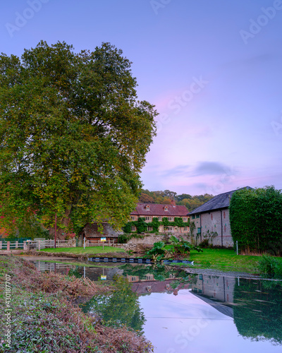 Stedham, UK - October 20, 2020:  Autumn colours and sunset on the River Rother and Stedham Mill in the South Downs National Park, West Sussex, UK © Julian Gazzard