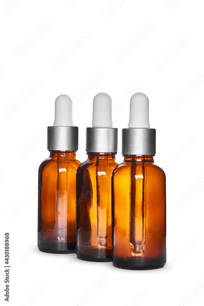 three amber dropper glass bottles on white background. Isolated and mockup