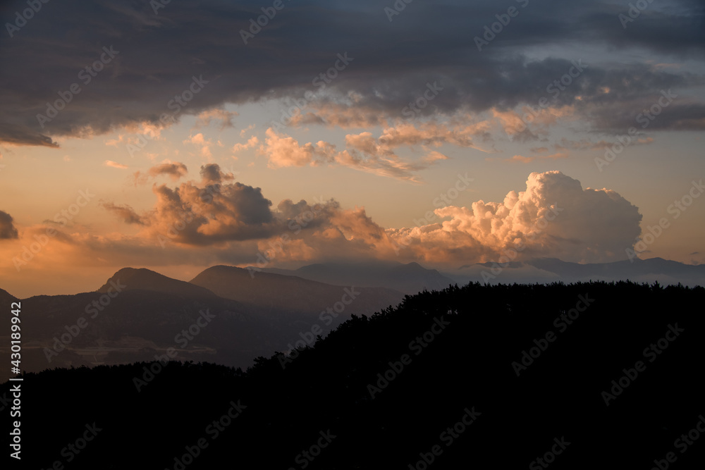 view of sky with big colorful clouds over mountain landscape. Beauty in nature.