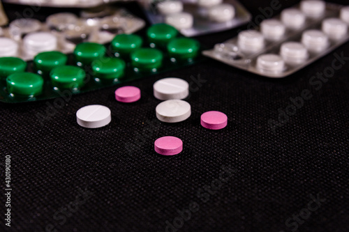 Antibiotic pills on a black background. Healthcare and medicine concept