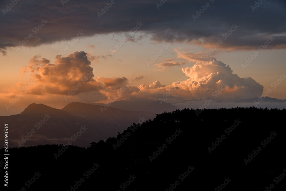 gorgeous view of sky with big colorful clouds over mountain silhouette. Beauty in nature.
