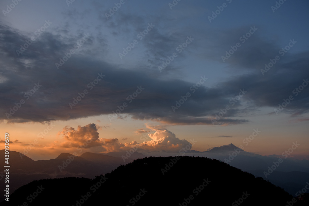 magnificent view of sky with big colorful clouds over mountain silhouette. Beauty in nature.