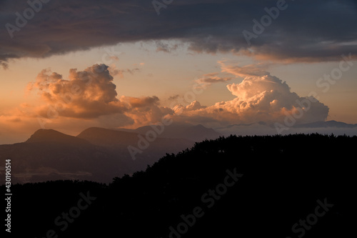 gorgeous view of sky with big colorful clouds over mountain silhouette. Beauty in nature.