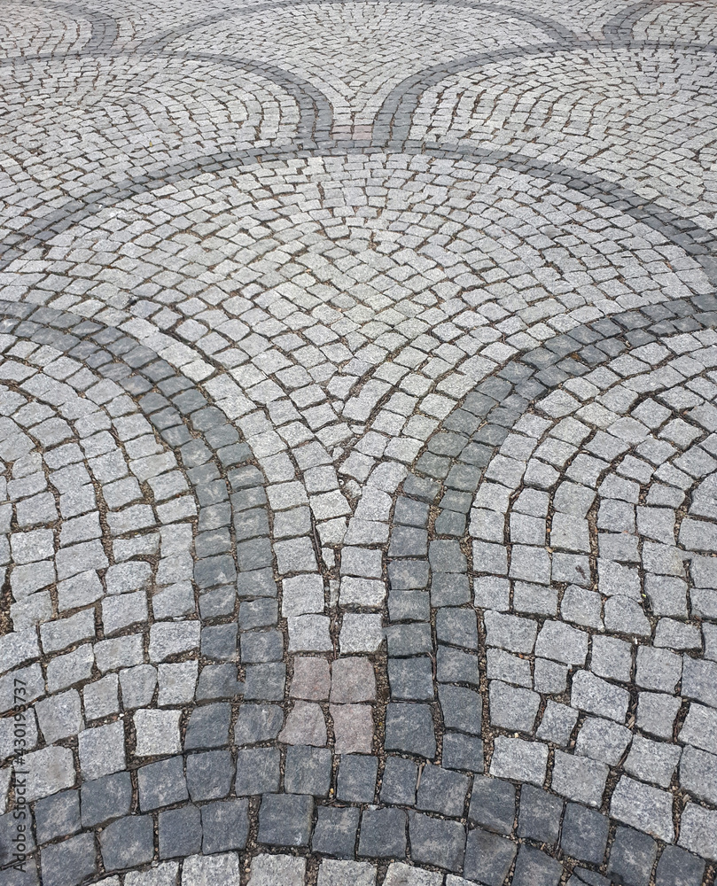 Decorative sidewalk folded from granite cobblestone, vertical shot Decorative sidewalk folded from granite cobblestone, vertical shot