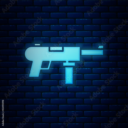 Glowing neon Submachine gun M3, Grease gun icon isolated on brick wall background. Vector