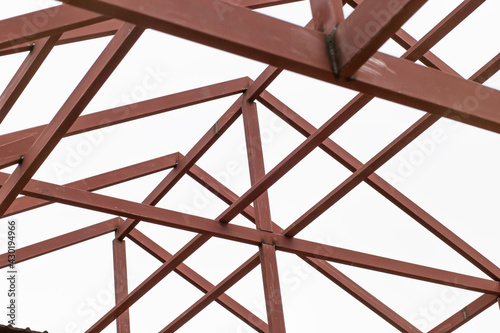 Steel roof structure painted with brown rust-proof paint, white background.