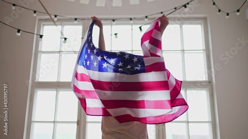 4k 10 bit. American winner. US flag. National celebration. Silhouette of a woman in the background of a window