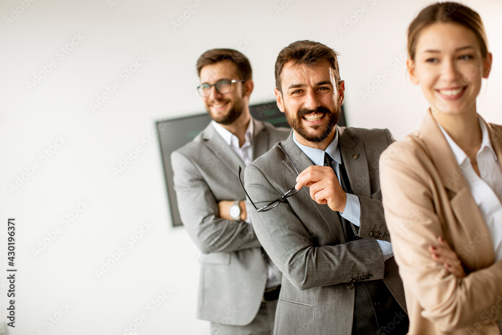 Young business people standing in a row together Young business people standing in a row together