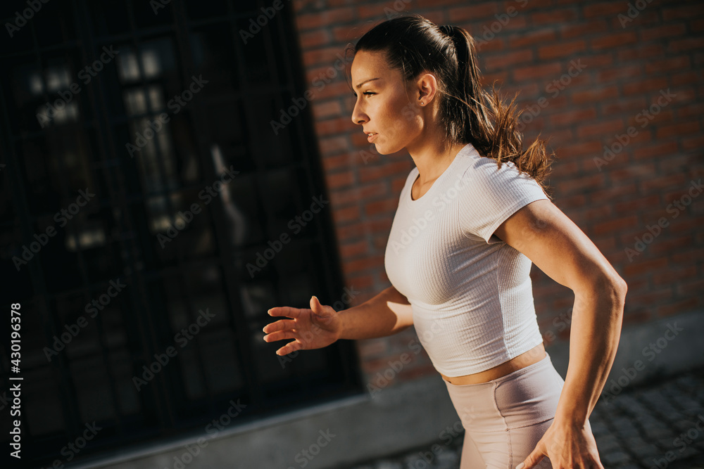 Young woman running on the street
