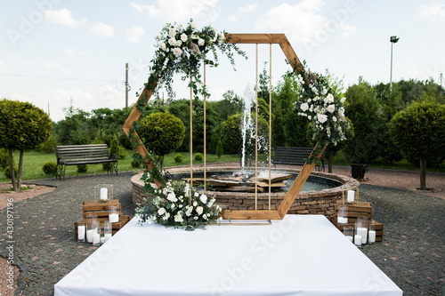 Wedding ceremony with arch in rustic style with fresh flowers