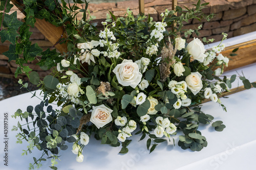 Close up of wedding eco decor with white fresh white flowers on wood arch