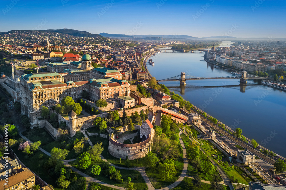 Budapest, Hungary - Aerial skyline view of beautiful Buda Castle Royal Palace and South Rondella at sunrise with Szechenyi Chain Bridge, River Danube, Matthias Church and Parliament of Hungary