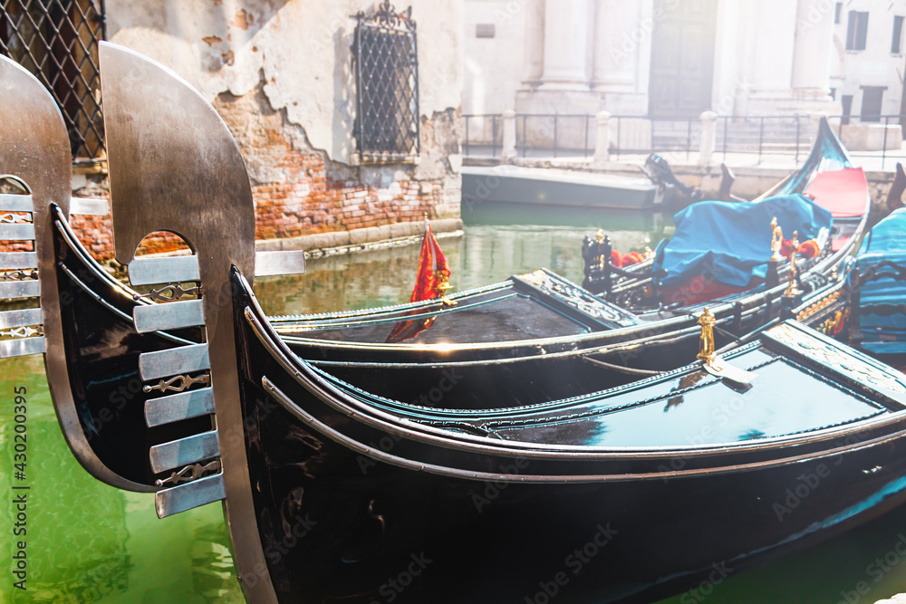 Prows of two moored gondolas, what represent symbol of Venice - Venezia, Italy, Europe
