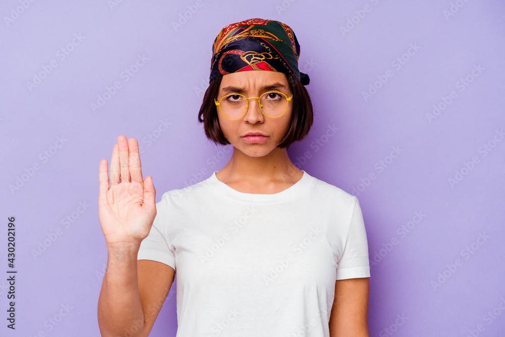 Young mixed race woman wearing a bandana isolated on purple background standing with outstretched hand showing stop sign, preventing you. Young mixed race woman wearing a bandana isolated on purple background standing with outstretched hand showing stop sign, preventing you.