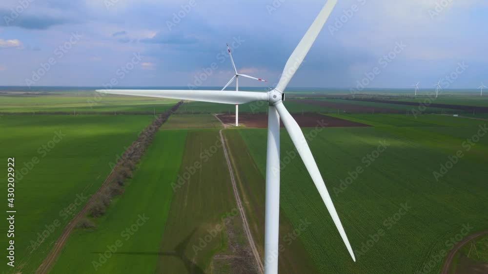 Wind farms that generate clean renewable energy for sustainable development. Alternative energy. Large wind turbines with blades in the field aerial view. Wind farms that generate clean renewable energy for sustainable development. Alternative energy. Large wind turbines with blades in the field aerial view.