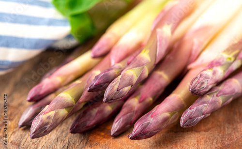 Fresh sprouts of white asparagus. Bunches of asparagus on a cutting board close-up.