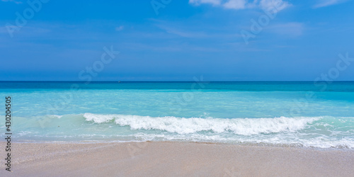 Panorama of turquoise sea  blue sky and sandy beach