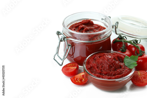 Bowl and jar of tomato paste, and tomatoes isolated on white background