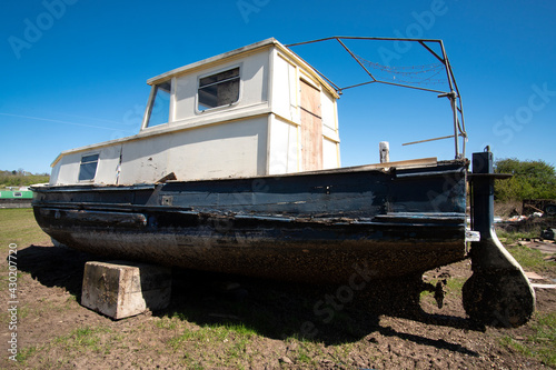 Old fashioned obsolete boat in a salvage yard