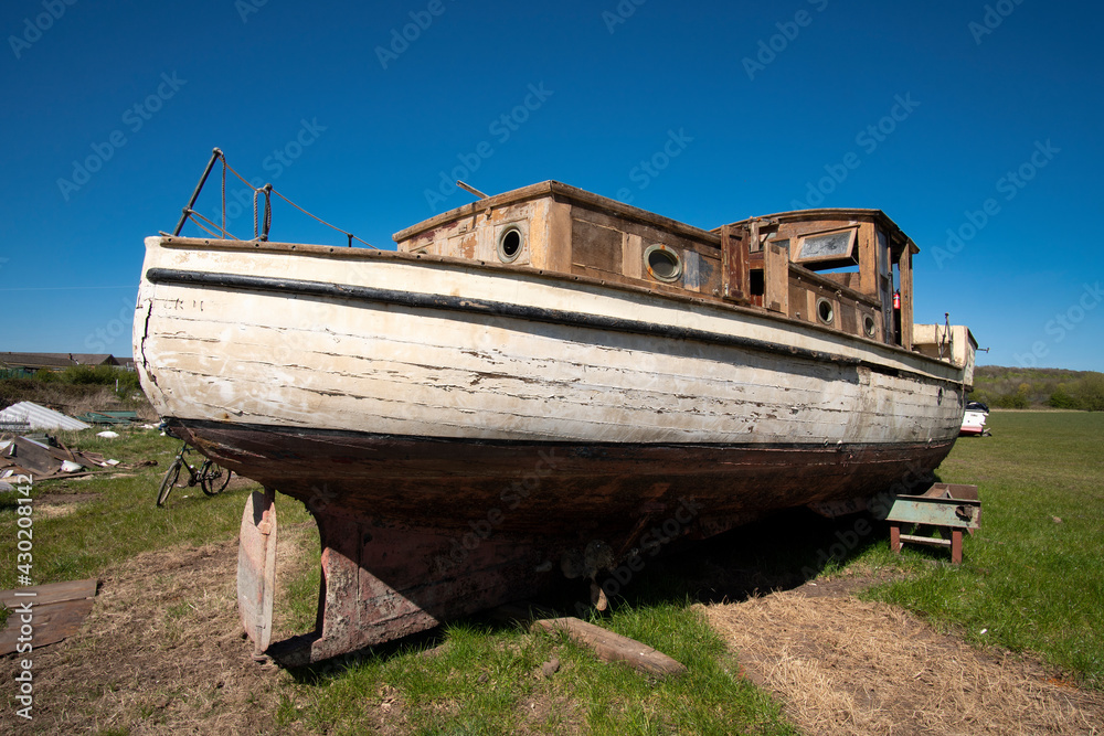 Old fashioned obsolete boat in a salvage yard