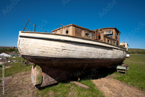 Old fashioned obsolete boat in a salvage yard