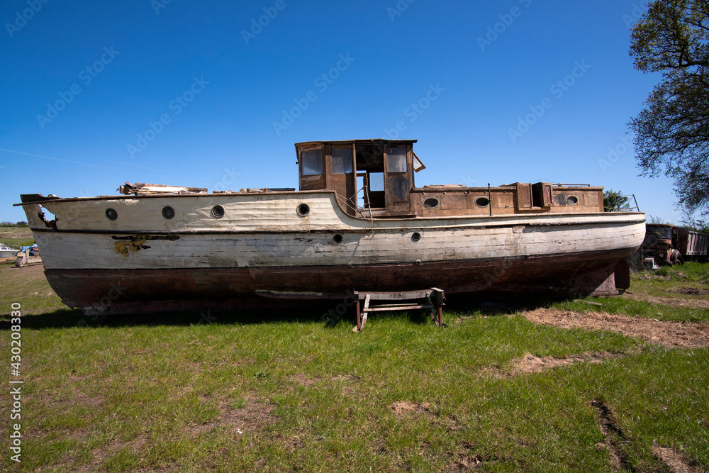 Old fashioned obsolete boat in a salvage yard Old fashioned obsolete boat in a salvage yard