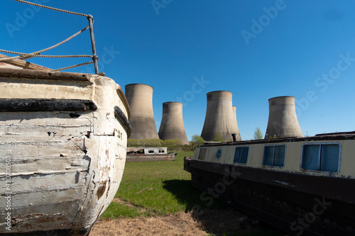 Old salvaged boats near a power station photo