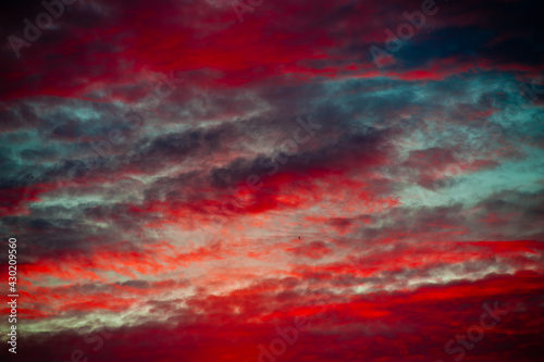 The red colors of the summer sunset sky. Beautiful clouds © E.O.